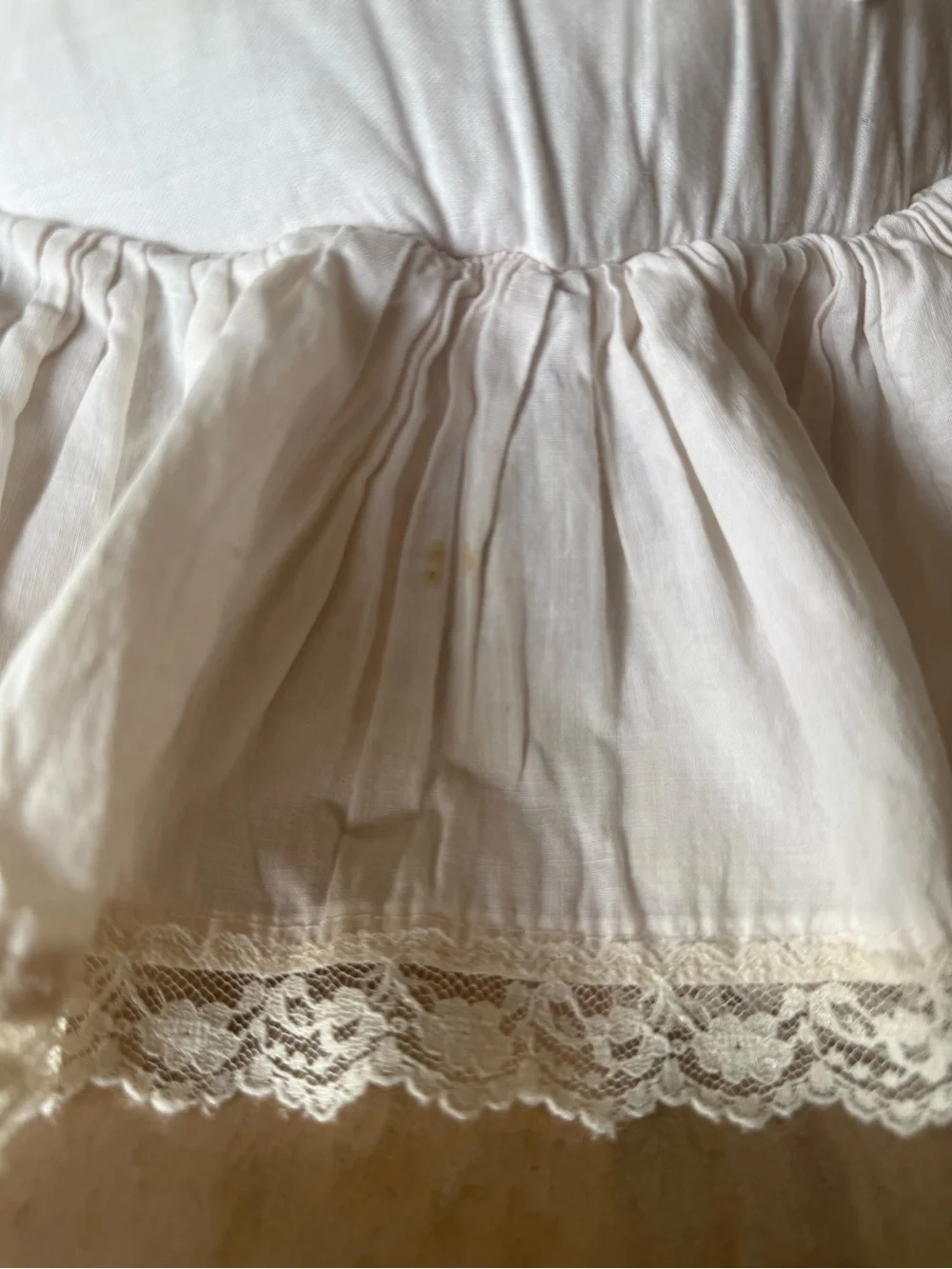 Handmade white candlewicking starburst pillow with ruffled lace trim.